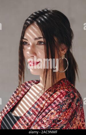 Portrait of beautiful and confident businesswoman standing in new office. Creative portrait using light and shadow play. Stock Photo