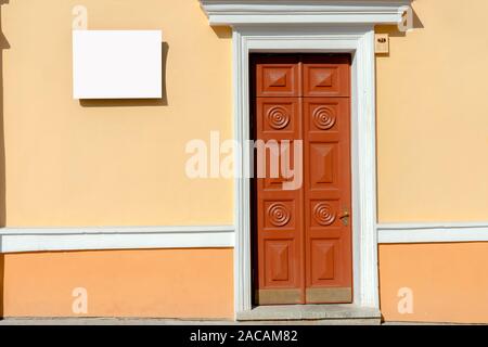 Mock up. Rectangular shape signboard near old wooden door outdoors Stock Photo