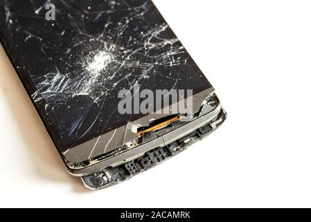 Old phone with broken screen isolated on white background Stock Photo