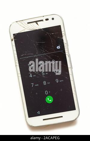 Old phone with broken screen isolated on white background Stock Photo