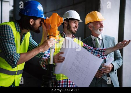 Engineer, contractor, architect teamwork. Construction people talking and planning work, blueprint Stock Photo