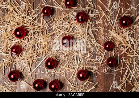Christmas background of wooden floor with dry straw and Christmas balls Stock Photo
