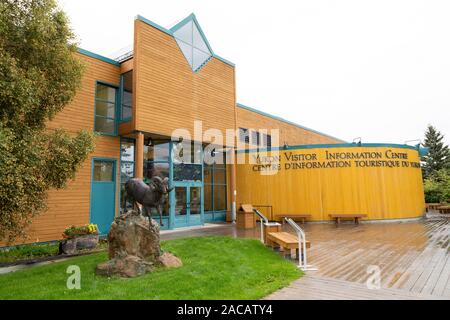 The Yukon Visitor Information Centre in Whitehorse, the Yukon, Canada. A sculpture of a dall sheep stands outside of the building. Stock Photo