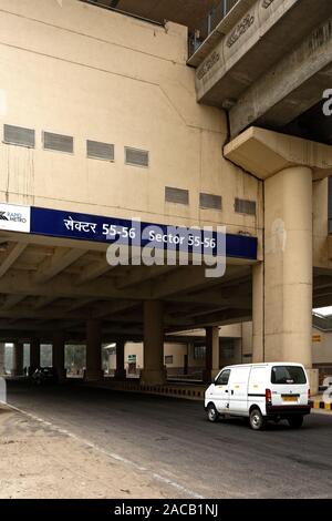 Small white van driving us Sector 55-56  Rapid Metro Station in Gurgaon, Haryana, India Stock Photo