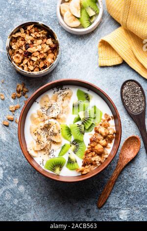 Smoothie or smoothy bowl with granola, fruits and seeds. Superfood breakfast bowl Stock Photo