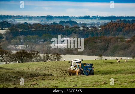 Clitheroe, Lancashire, UK. 2nd Dec 2019. An ideal time to get the farmyard manure spread on the frozen fields at Cow Ark, Clitheroe, Lancashire an a cold winter's morning. Credit: John Eveson/Alamy Live News Stock Photo