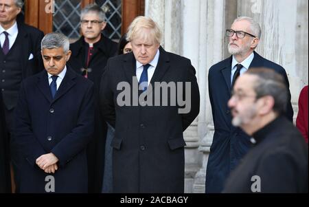 (left to right) Mayor of London Sadiq Khan, Prime Minister Boris Johnson and Labour leader Jeremy Corbyn take part in a vigil in Guildhall Yard, London, to honour the victims off the London Bridge terror attack, as well as the members of the public and emergency services who risked their lives to help others after a terrorist wearing a fake suicide vest went on a knife rampage killing two people, was shot dead by police on Friday. Stock Photo