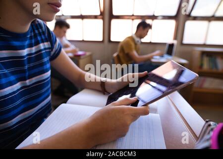 Teenagers in school classroom Stock Photo