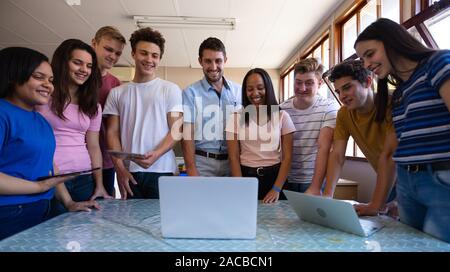 Teenagers and teacher in classroom Stock Photo