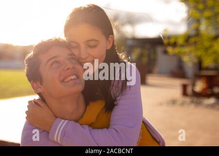 Teenager couple hanging out in their school grounds Stock Photo