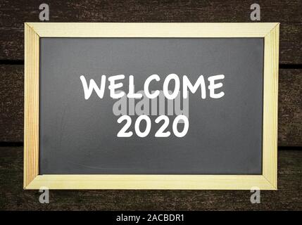 Welcome 2020, typed white text on black board. Stock Photo