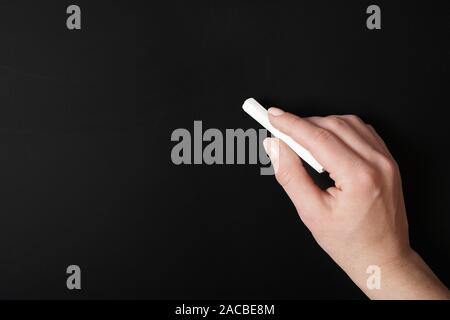 hand writing with chalk on blank chalkboard background Stock Photo