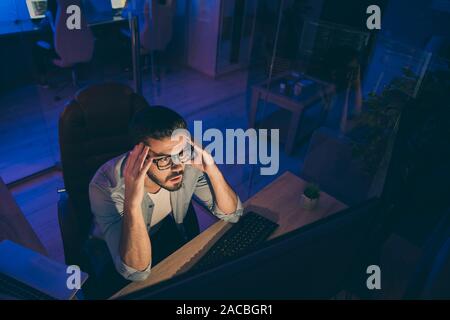 Hign angle above view photo of it skilled specialist guy sitting chair looking many monitors not believe eyes analyzing server back-end security bad Stock Photo