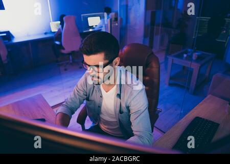 Photo of it specialist guy sitting chair seriously looking many monitors writing secure code for website calculate algorithms content development Stock Photo
