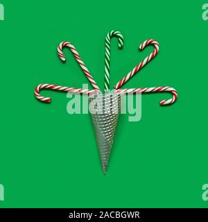 Creative minimal Christmas art. Pattern made with Christmas candies on green background Stock Photo