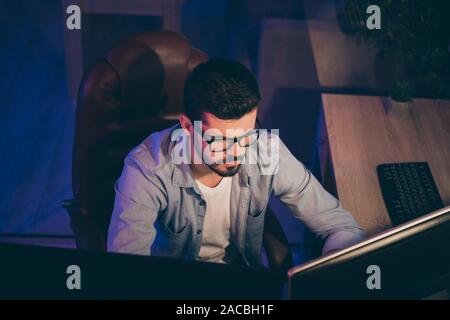 Photo of it specialist guy sitting chair seriously looking many monitors writing secure code for website calculate algorithms content development Stock Photo