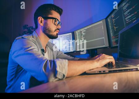 Profile side view portrait of his he nice attractive focused skilled guy writing cyber attack hack web network hardware software protection trouble Stock Photo