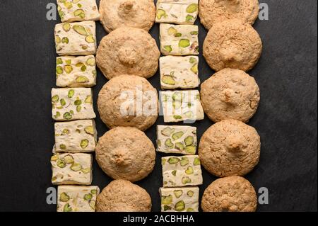 Pattern of almond biscuits and nouvas on a dark background Stock Photo