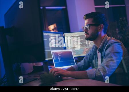 Profile side view portrait of his he nice attractive skilled focused serious guy writing script ai tech support devops creating digital solution front Stock Photo