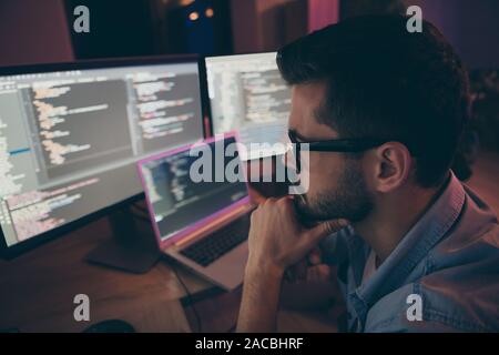 Close-up profile side view portrait of his he nice attractive skilled expert focused concentrated guy monitoring remotely web project start-up hard Stock Photo