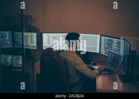 Photo of it-specialist working on global project using laptop testing alpha version of newly developed software checking bug existence debugging Stock Photo