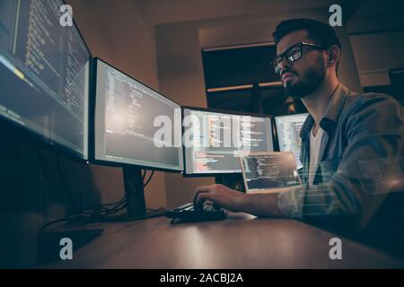 Profile side view of nice attractive serious skilled qualified smart clever bearded brunet guy nerd building fixing extracting file editing framework Stock Photo