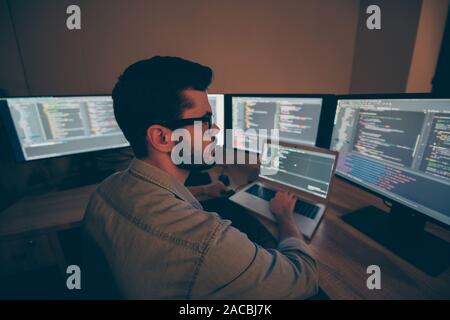 Photo of C specialist serious thinking on improving the code of securing software to prevent hackers from cyber attacking the servers of corporation Stock Photo