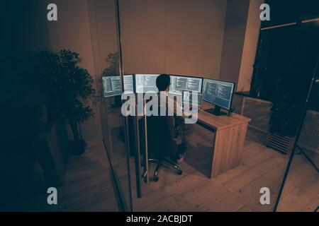 Top above high angle view photo of programmer ensuring normal work of server responsible for cyber security working with java script and C holding Stock Photo