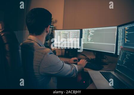 Profile side view of nice senior devops qualified expert focused brunette guy writing source solving tech problem checking database making report in Stock Photo
