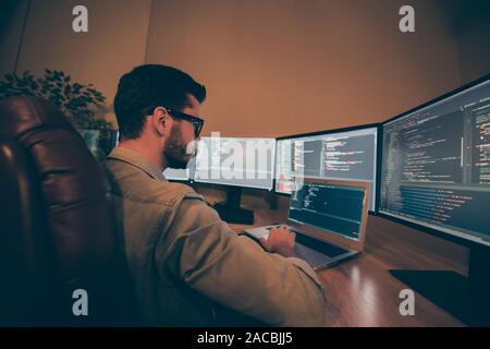 Profile side view of his he nice senior qualified skilled focused smart clever brunet guy testing web site fixing bugs tracking creating qa report Stock Photo