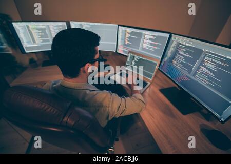 Above high angle view of his he nice senior cool qualified skilled smart clever brunet guy testing app hacking creating qa quality assurance report in Stock Photo