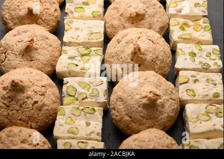 Pattern of almond biscuits and nouvas on a dark background Stock Photo
