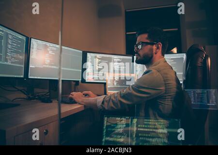 Photo of programmer serious writing code to software which will be involved into large projects connected with artificial intelligence analyzing time Stock Photo