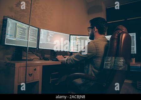 Profile side view of his he nice senior devops expert guy sitting in chair solving tech problem coding mysql html php laravel language database Stock Photo