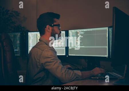 Profile side view of his he nice attractive focused serious skilled qualified brunet guy making outsource optimization hardware software display Stock Photo