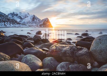 Rocks on the beach modeled by the wind surround the icy sea Unstad Lofoten Islands Norway Europe Stock Photo