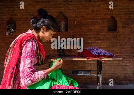 Tailor woman is working with green fabric Stock Photo