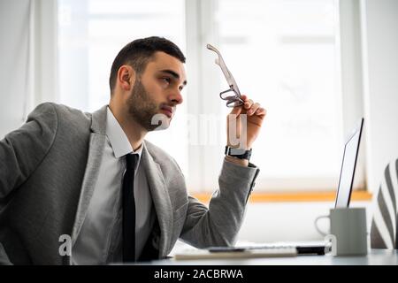 Young pensive businessman is working in office. Stock Photo