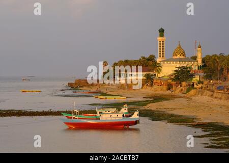 Indonesia Kupang city Coastline with fishing boats and mosque Nurul Hidayah Stock Photo