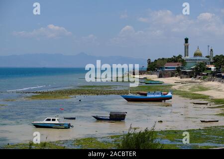 Indonesia Kupang city Coastline with fishing boats and mosque Nurul Hidayah Stock Photo