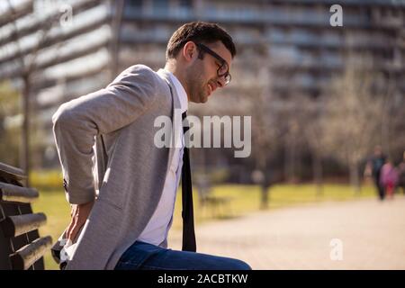 Young businessman is having pain in his back. Stock Photo