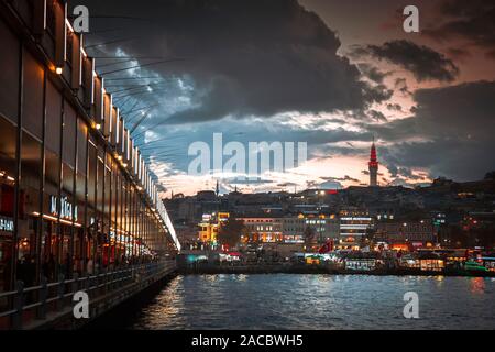 Istanbul, Turkey: November 30, 2019: Galata Bridge and fire observe tower during twilight Stock Photo