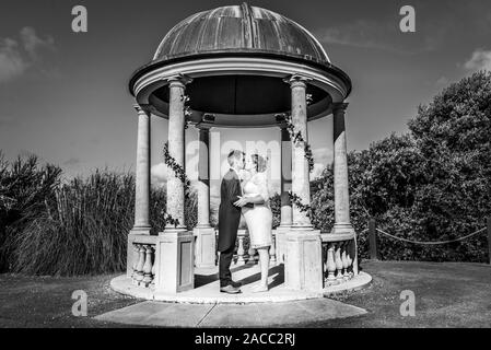 A mixed race couple married at Tregenna Castle Resort and Carbis Bay Beach, Seaside village, Saint Ives, (Caucasian, Black), pregnant bride, pregnancy Stock Photo