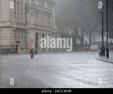 London, England, UK. Cyclist in torrential rain Stock Photo