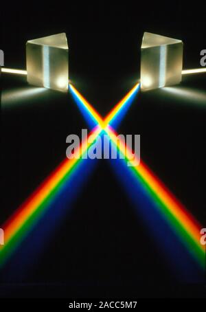 Multiple exposure of white light through a triangular prism, which spilts the light into the spectral colours. Stock Photo