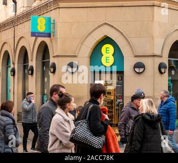 Belfast, Northern Ireland, UK - November 30, 2019: People walk past the entrance to the EE Phone shop, Arthur Square