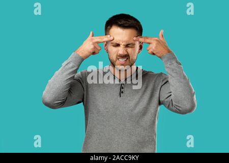 portrait of doubtful bearded man isolated on blue background. Stock Photo