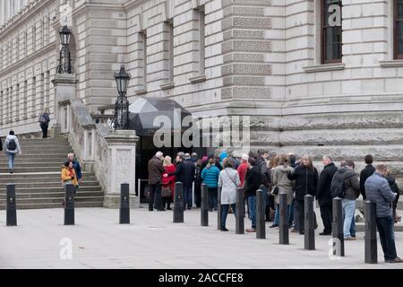 Visitors queue to enter the Imperial War Museums Churchill War Rooms entrance located at Horse Guards Road, London, England. During World War II Prime Stock Photo