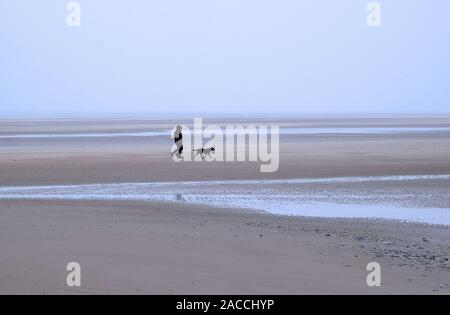 dog walkers on wells-next-the-sea beach, north norfolk, england Stock Photo