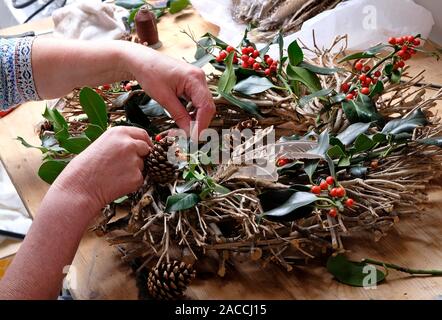 female person making a christmas wreath Stock Photo